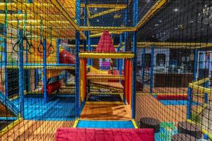 a play room with a playground with a slide at Lila aan zee - Recreatiepark de Watersnip in Petten