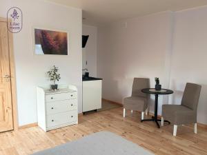 a living room with a table and two chairs at Lilac room in Ozolnieki