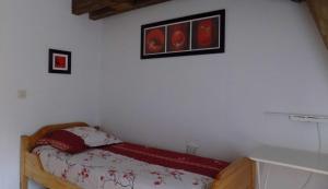 a bedroom with a bed and pictures on the wall at Habitation Occitania in Durban-Corbières