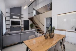 a living room with a table and a couch at G-Ammos 5 Star Villa by elite in Tragaki