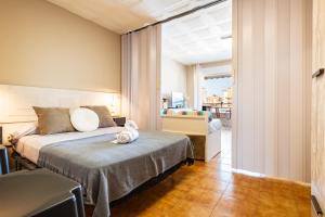a hotel room with a bed and a balcony at Azul Turquesa in Peniscola +17 photos
