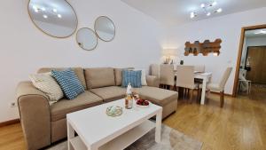 a living room with a couch and a table at Island Dream Apartment in Olhão