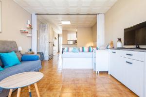 a living room with a couch and a table at Azul Turquesa in Peniscola