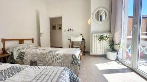 a bedroom with two beds and a potted plant at Ca' Adriana in Lido di Jesolo