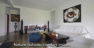 a living room with a white couch and a coffee table at DuriDuri Eco Resort in Bentong +5 photos