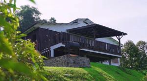 a house on top of a green hill at DuriDuri Eco Resort in Bentong