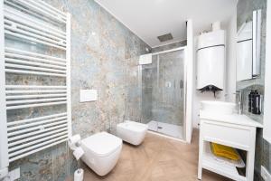 a bathroom with a toilet and a sink and a shower at Seven Thousand Apartment in Brescia