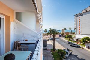 a balcony with a table and a view of a street at Azul Turquesa in Peniscola