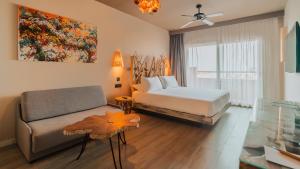 a hotel room with a bed and a couch at Hotel Tarifa Lances, a member of Radisson Individuals in Tarifa +166 photos
