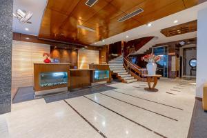 a living room with a staircase and a lobby at Hotel Aura - 05 Mins from New Delhi Railway Station & Connaught Place in New Delhi
