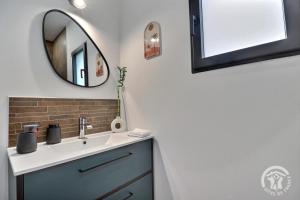 a bathroom with a sink and a mirror at Le four in Saint-Georges-de-Chesné +14 photos