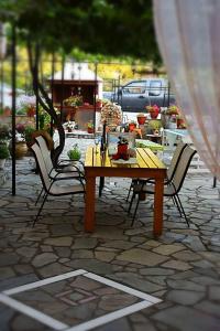 a wooden table and chairs on a patio at Foteini Rooms in Skala Sotiros