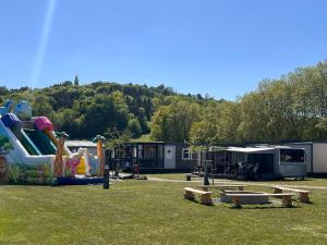 a playground with a slide in a park at Camping Resort Riegersburg in Riegersburg