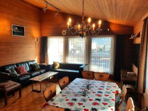 a living room with a table and a couch at Haus Nussbaumweg 6 in Giswil