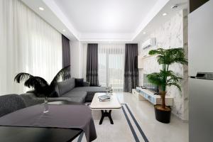 a living room with a couch and a table at Annabella Residence in Alanya