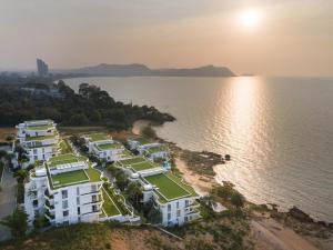 an aerial view of a resort next to the water at Pure Sunset Beach - By Mikihollick in Na Jomtien