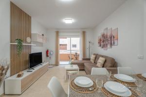 a living room with a couch and a table at Brisa Caletillas in Punta Larga
