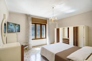 a bedroom with a large bed and a chandelier at Seaside House in Paestum