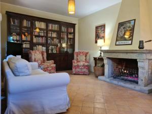 a living room with a white couch and a fireplace at Villa Flavia in Manziana