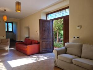 a living room with two couches and a sliding glass door at Villa Flavia in Manziana