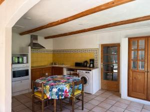 a kitchen with a table and a stove at Ma maisonnette en Cévennes in Le Vigan