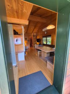 a large room with a kitchen and a living room at Seewaldhüttn in Oberaichwald