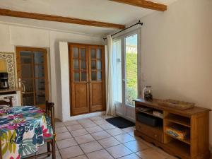 a bedroom with a bed and a window and a door at Ma maisonnette en Cévennes in Le Vigan +20 photos