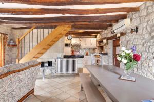 a kitchen with a table and a counter top at Gîte Roses De Loire in Bréhémont