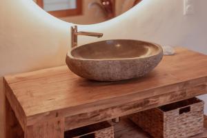 a bathroom sink sitting on a wooden table with a sink at Maison POHESY in Figeac +23 photos