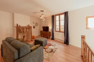 a living room with a couch and a chair at Maison POHESY in Figeac