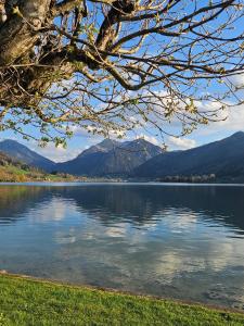 a view of a lake with mountains in the background at Ferienwohnungen am See _ Hinterseer in Schliersee