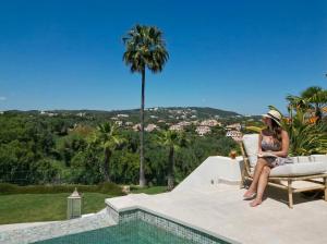 a woman sitting in a chair on top of a house at Villa Kahuna Sotogrande in Sotogrande