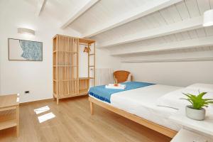 a bedroom with a large bed and a wooden floor at Villa Gabbiano - Scopello-Villas in Scopello