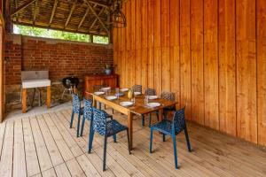 a wooden table and chairs on a wooden deck at La maison d'eugénie in Jourgnac