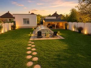 a backyard with a tent in the grass at Pet-house in Trstice