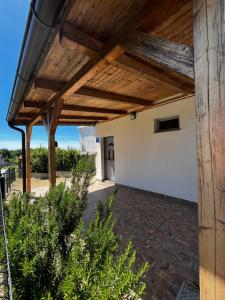 an outdoor patio with a wooden pergola at Holiday House Sanja Private Terrace BBQ in Peaceful Surroundings in Medulin