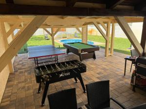 a patio with a ping pong table and a pool table at Pet-house in Trstice