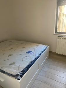 a bed sitting in a room with a mattress at SeaYouSoverato Apartment in Soverato Marina