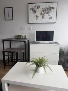 a living room with a table and a laptop computer at The Parade, Market Square room 3 in Northampton