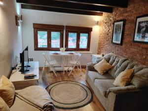 a living room with a couch and a table at El Mirador in Cudillero +12 photos