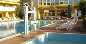 a swimming pool with chairs and a hotel at Hotel Malaspina in Bosa +21 photos