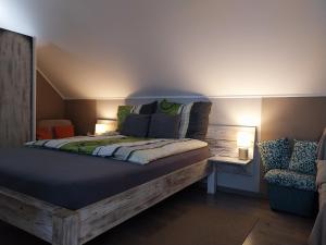 a bed with pillows on it in a room at Kovács Vendégház in Bük