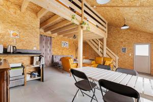a kitchen and dining room with a table and chairs at Le Nid in Abbaretz