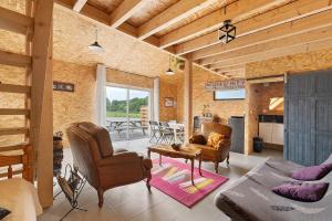 a living room with a couch and chairs and a table at Le Nid in Abbaretz