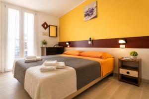 a bedroom with a large bed with towels on it at Hotel Cesari in Rimini