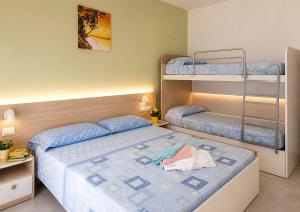 a small bedroom with two bunk beds and a bed at Hotel Cesari in Rimini +68 photos