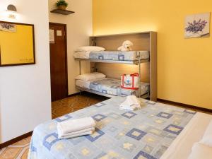 a bedroom with two bunk beds with a teddy bear at Hotel Cesari in Rimini