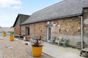 a stone building with chairs and a patio at Le Nid in Abbaretz +17 photos