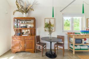 a dining room with a table and a cabinet at Cozy Countryside Studio in Aldeia do Cano