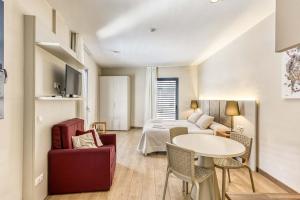 a hotel room with a bed and a table and chairs at Aparthotel 1904 in Figueres